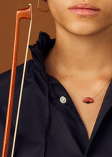 Load image into Gallery viewer, Gold chain necklace with flamenco fan shaped red coral worn by model
