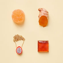 Load image into Gallery viewer, Composition with dragon fruit coral necklace and orange food
