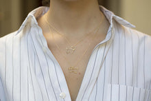 Load image into Gallery viewer, Gold chain necklace with dog shaped pendant and small diamond worn by model
