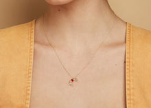 Load image into Gallery viewer, Gold chain necklace with croissant shaped pendant hand-painted in raspberry enamel worn by model
