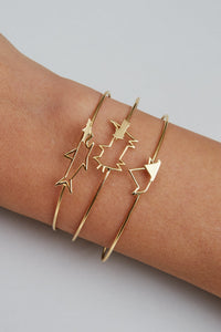Gold bangle bracelets worn by model