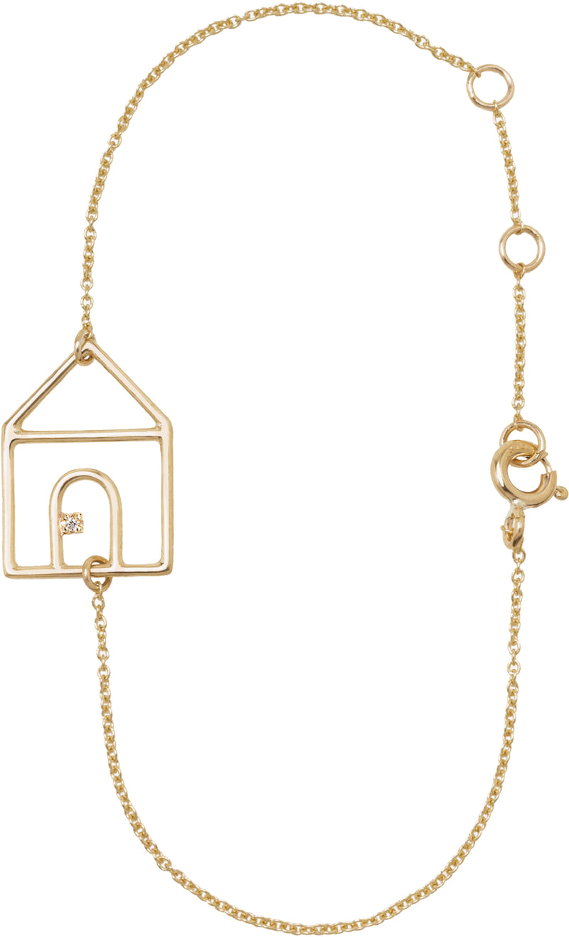 Gold chain bracelet with house shaped pendant and small diamond