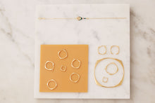 Load image into Gallery viewer, Jewelry composition with gold hoop rings, earrings and bracelets
