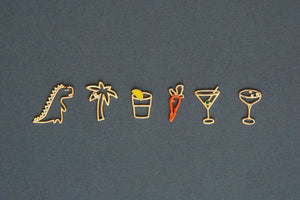 Jewelry gold pendants shaped like dinosaur. palm tree, carrot, tequila shot, martini drink