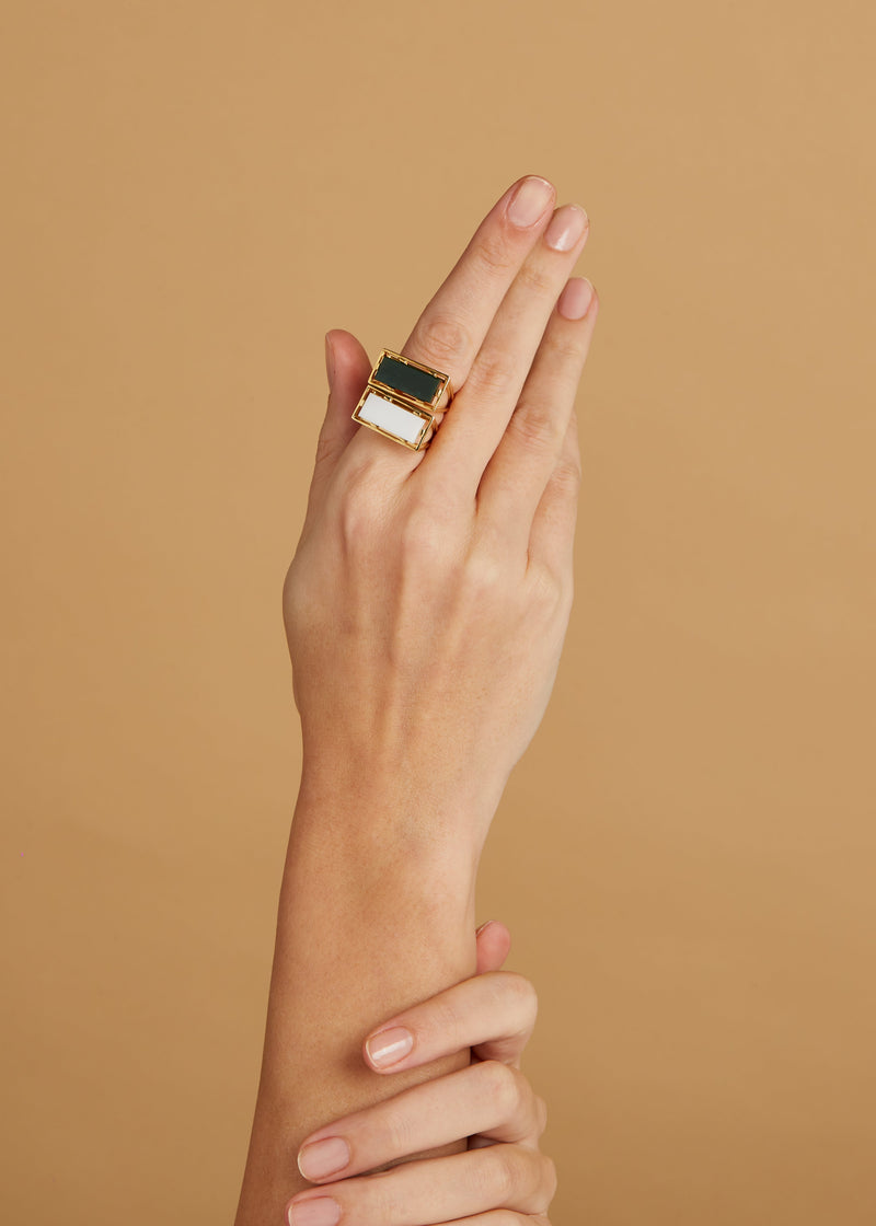 Gold square rings with jasper stone and white agate on woman's hand