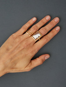 Gold rings and cameo ring on woman's hand