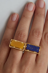 Gold square ring with lapis lazuli stone and yellow jade on woman's hand