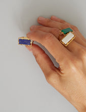 Load image into Gallery viewer, Hand with gold rings with lapis and white agate stones
