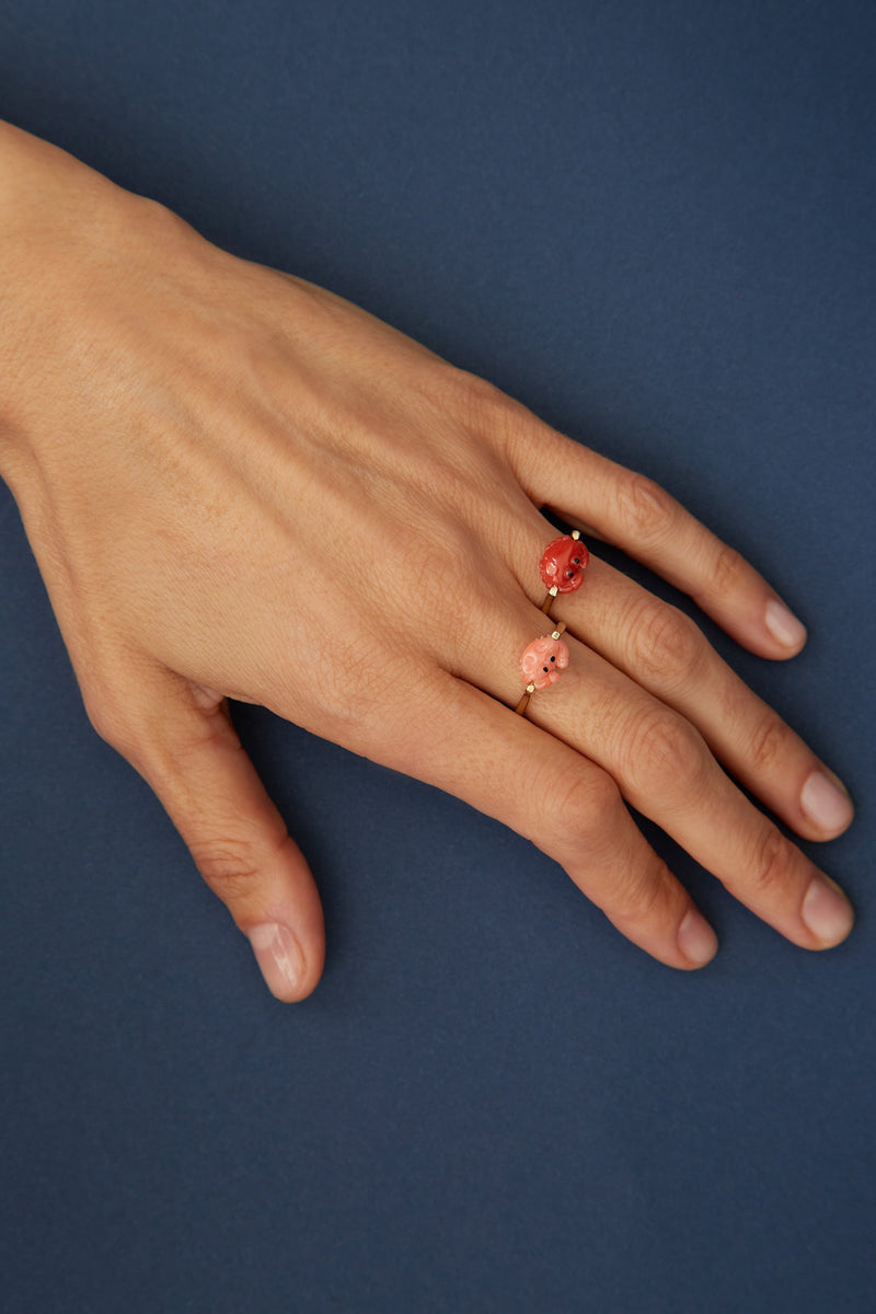 Gold ring with mini red crab shaped coral worn by model
