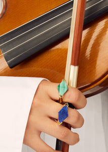Gold ring with stones in rhombus cut worn by model