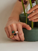 Load image into Gallery viewer, Hands wearing gold rings with precious stones
