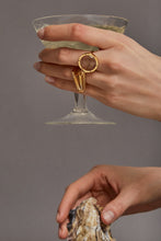 Load image into Gallery viewer, Hands wearing a gold ring with a round rutile quartz and a gold ring with citrine stone
