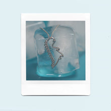 Load image into Gallery viewer, White gold chain necklace with dinosaur shaped pendant on ice cubes
