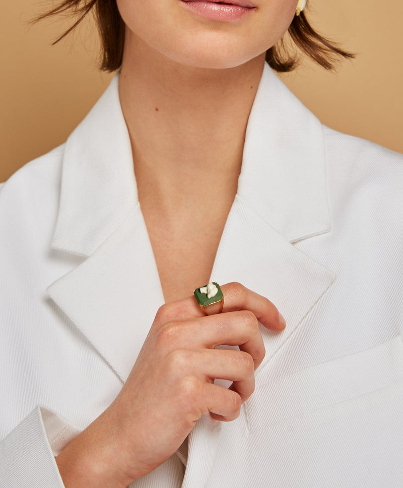 Model wearing gold ring with broccoli cameo in green porcelain