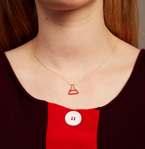 Gold chain necklace with small chemistry baker pendant hand-painted in red enamel on model
