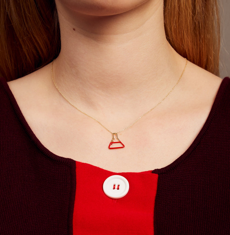 Gold chain necklace with small chemistry baker pendant hand-painted in red enamel on model