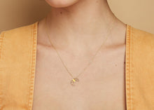 Load image into Gallery viewer, Gold chain necklace with croissant shaped pendant hand-painted in cream enamel worn by model
