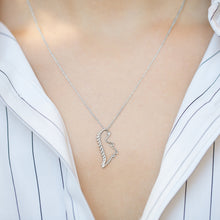 Load image into Gallery viewer, White gold chain necklace with dinosaur shaped pendant worn by model
