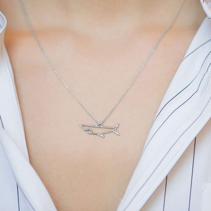 White gold chain necklace with shark shaped pendant worn by model