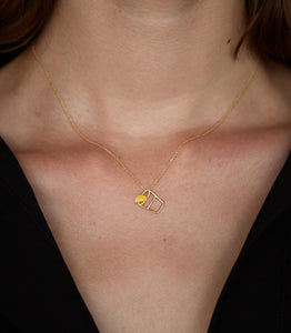 Gold chain necklace with tequila shot shaped pendant worn by model