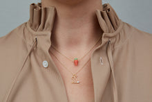 Load image into Gallery viewer, Model wearing gold chain necklaces with carrot shaped coral pendants and rabbit shaped pendant with pearl
