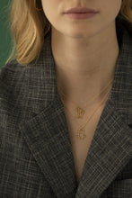 Load image into Gallery viewer, Gold chain necklace with space shuttle shaped pendant worn by model
