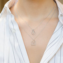 Load image into Gallery viewer, Model wearing white gold chain necklaces with house and light bulb chain pendants
