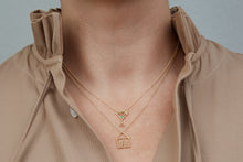 Load image into Gallery viewer, Gold chain necklace with martini drink shaped pendant and small emerald worn by model
