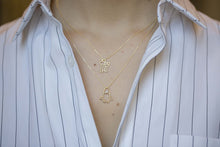 Load image into Gallery viewer, Gold chain necklace with space shuttle shaped pendant with pearl worn by model
