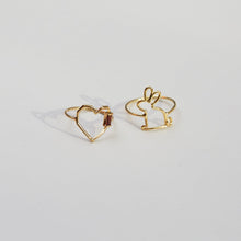 Load image into Gallery viewer, Gold rings shaped like a heart with a garnet baguette stone and a little rabbit
