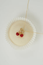 Load image into Gallery viewer, Creamy white pastry with a necklace with coral cherries as pendant on top
