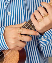 Load image into Gallery viewer, Model playing ukulele wearing gold rings
