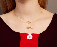Load image into Gallery viewer, Woman wearing two gold chain neckalces with a crocodile shaped pendant and a turtle shaped pendant with emeralds

