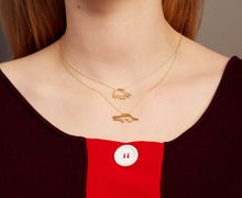 Load image into Gallery viewer, Woman wearing gold necklaces with a crocodile shaped pendant and a turtle shaped pendant with emeralds

