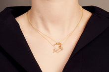 Load image into Gallery viewer, Woman wearing two gold necklaces with shrimp and whale shaped pendants with ruby and blue sapphire
